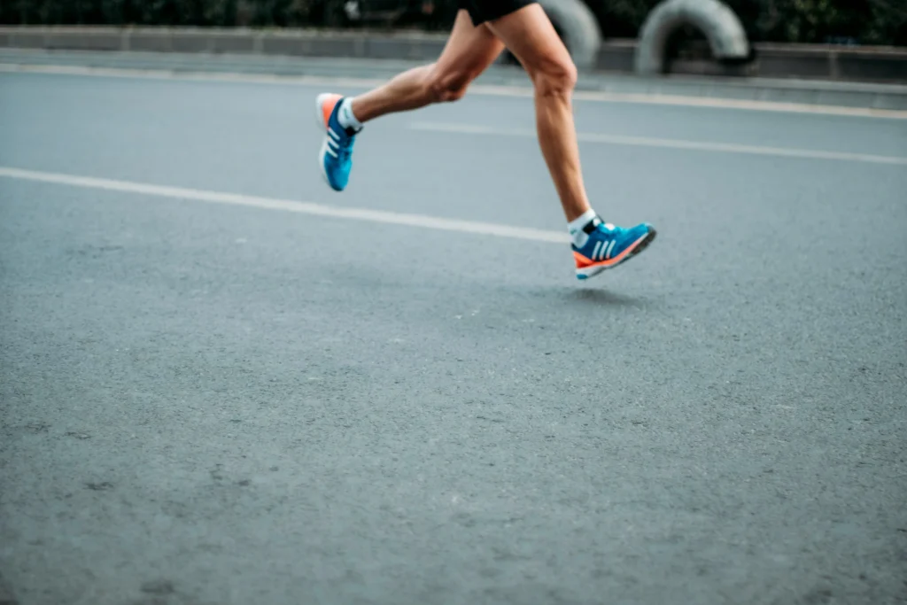 A runner training on a track at dawn
