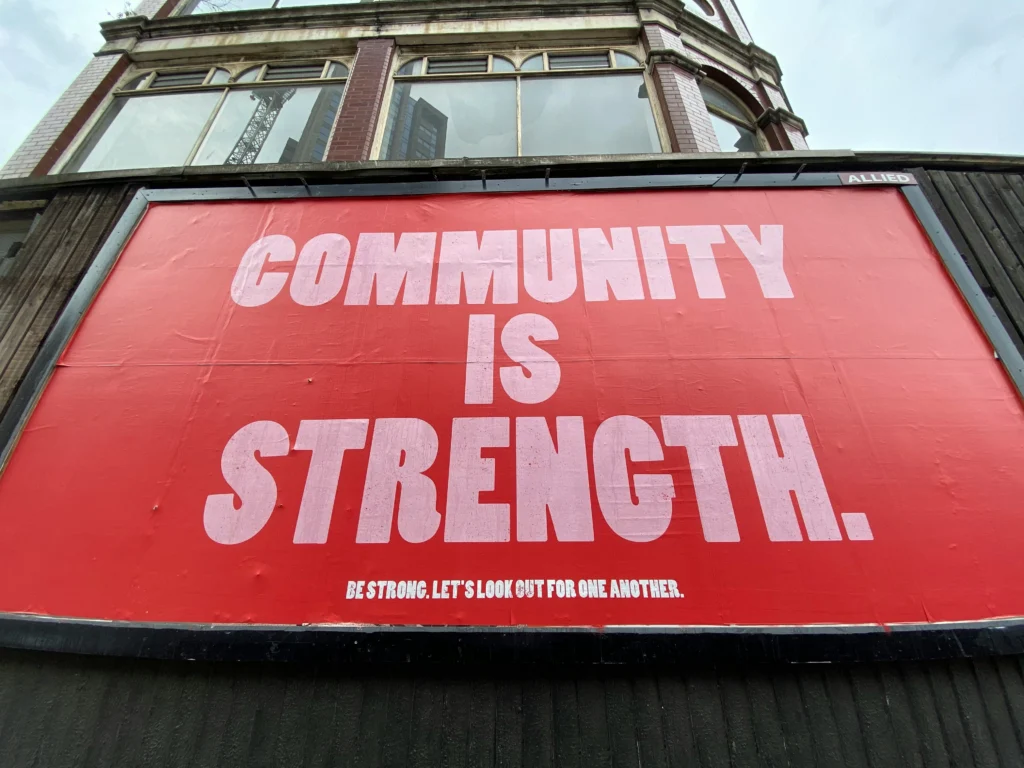 A red “Community is Strength” mural