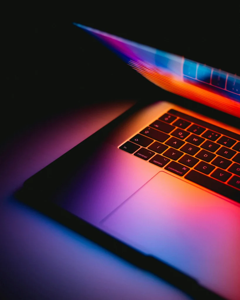 A laptop glowing in a dark room